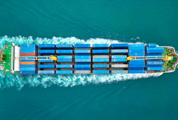 Shipping logistics. Commercial shipping. Cargo ship in sea, aerial view. Massive cargo ship. Freight container loaded on vessel. Aerial view cargo ship entering harbor. Cargo business. Container ship