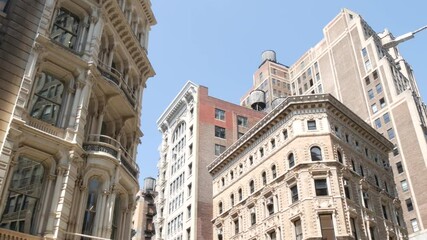 New York City Broadway, Manhattan midtown classic building corner architecture. Urban residential house exterior. Real estate property in USA. Typical brick facade. Rooftop water tower, tank on roof.