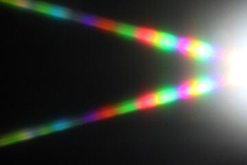 Rainbow reflective colorful sunlight on textured surface of wall. Dispersion and refraction of light.