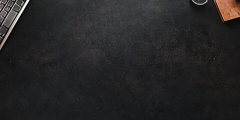 A deep charcoal black texture with soft highlights and subtle grain patterns