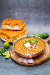 Pav Bhaji is a spicy, mashed vegetable curry served with soft buttered bread rolls, offering a comforting, savory experience.