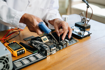 The technician repairing the motherboard in the lab with copy space. the concept of computer hardware,