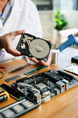 Obraz premium Technician repairing inside of hard disk drive by screwdriver. the concept of data, hardware, technician