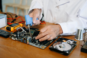 The technician repairing the motherboard in the lab with copy space. the concept of computer hardware,