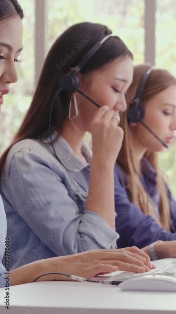 Poster customer support agent or call center with headset works on desktop computer while supporting the cu