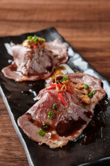 Close-up Wagyu Beef Nigiri Sushi on a Black Plate