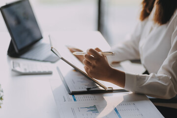 Thinking, research and tablet with asian woman writing in notebook in startup for management,...