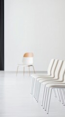Minimalist interior with white chairs and a simple backdrop.