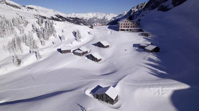 pushing out from grosse scheidegg with stunning views of alpine hotel and alpine cottages on a beautiful sunny winter day