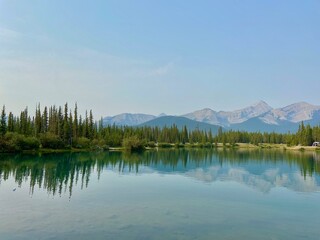 reflection of trees on lake in the mountains 