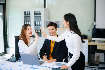 Asian business people discussing business plan at modern startup in creative business discussing work