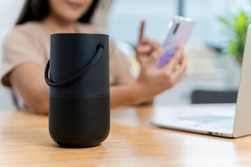 Closeup of smart portable wireless speaker on the table. Portable Wireless Speaker. Black Sound...