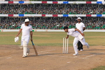 Spin bowler delivers the ball towards the batsman, during the cricket game