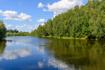 tranquil summer day by picturesque lake surrounded by dense forest, perfect for relaxation, picnics, and enjoying the fresh air in a peaceful natural setting