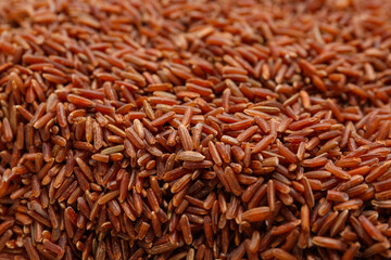 Raw brown rice as background, closeup