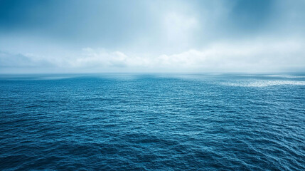 Fototapeta premium Deep blue ocean with penetrating sunlight showcasing vast underwater depth and solitude concept minimalistic bright tone modern blurred background with empty blank caption space on the side