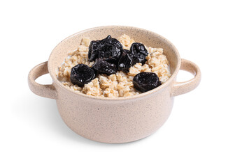 Pot of tasty oatmeal with prunes and milk on white background