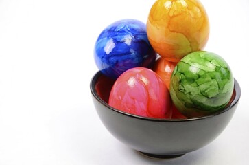 Colorful Easter eggs in a bowl with space for text