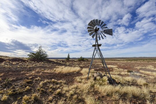 Pampa with old windmill on a farm in Bosques Petrificados de Jaramillo National Park, Patagonia, Argentina, South America