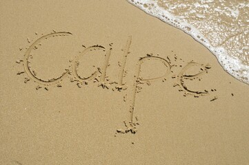 Calpe written in the sand, Calpe, Costa Blanca, Spain, Europe