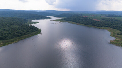 Drone shot. Aerial view scenic landscape of a large river delta amid a lush forest at the tropical...