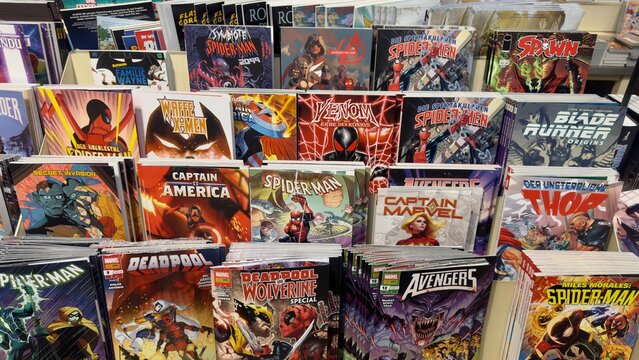  Germany, D&uuml;sseldorf Central Station, January 29, 2025. A display of various comic books featuring popular superheroes such as Spider-Man, Deadpool, Batman.. Marvel and DC Comics