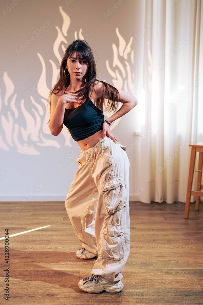 Poster dancer performs dynamic choreography in a modern studio with artistic lighting