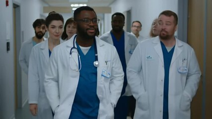 Medical team walking down hospital corridor