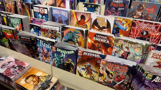  Germany, D&uuml;sseldorf Central Station, January 29, 2025. A display of various comic books featuring popular superheroes such as Spider-Man, Deadpool, Batman.. Marvel and DC Comics