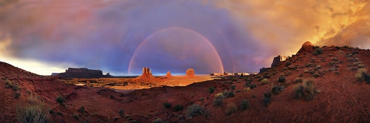 Panorama with Sentinel Mesa, West Mitten Butte, East Mitten Butte and Merrick Butte, with Rainbow,...
