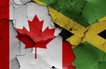 Flags of Canada and Jamaica painted on cracked wall