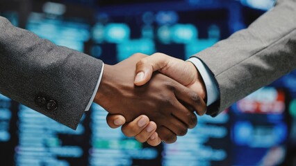 Powerful Partnership, Diverse Businesspeople Shake Hands Against a Dynamic Data Background