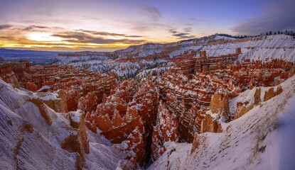 Amphitheatre at sunrise, snow-covered bizarre rocky landscape with Hoodoos in winter, Rim Trail,...