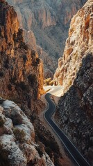 Winding road through a sunlit canyon.