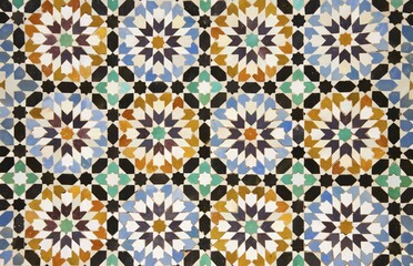 Detail of colourful geometric zellige tileworks in the central courtyard of the Ben Youssef Madrasa, Marrakesh, Morocco, Africa
