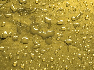 Water drops on golden color metallic surface