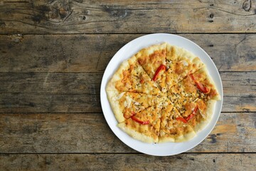 Kiln baked pizza on wooden table
