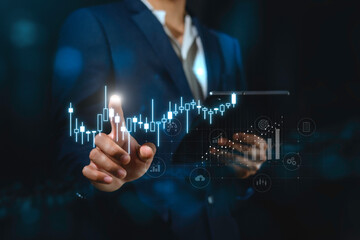 investment and finance concept, businessman holding virtual trading graph and blurred light on...