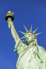 Fototapeta premium Statue of Liberty in front of blue sky, Liberty Island, Statue of Liberty National Monument, New York City, New York, USA, North America
