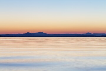Sunset behind Hegau Volcano Hohenstoffeln, Hohentwiel, Hohenhewen, Hohenkrähen, Mägdeberg and Radolfzell, Reichenau Island, Reichenau, Baden-Württemberg, Germany, Europe