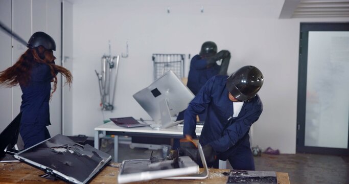 Demolition, weapon and people in rage room for anger management, cathartic therapy and stress relief. Bat, safety gear and golf club with people in smash center with emotion, break and vandalism