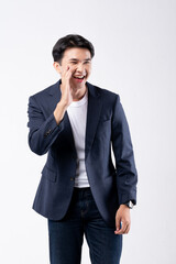 A man in a blue suit and white shirt poses for a photo