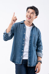 A man in a blue shirt is pointing to the sky with his finger