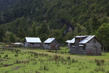 Traditional Chilean wooden huts on a meadow on the Carretera Austral, Ruta CH7 road, Panamerican...