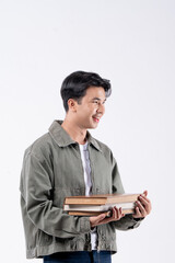 A young man and holding a stack of books