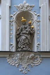Holy sculpture, Madonna with the baby Jesus wearing golden crowns in a wall niche of a town house,...
