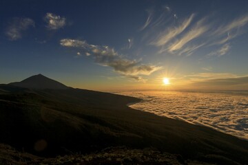 Volcano Pico del Teide at sunset, over clouds, Teide National Park, Canary Islands, Tenerife,...