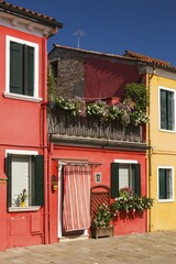 Red house facade decorated with flowers, Burano Island, Venice, Veneto, Italy, Europe