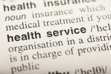 Health service, text in dictionary. macro shot. selective focus