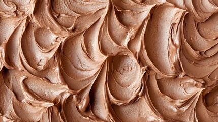 Creamy chocolate frosting swirled with precision on a flat surface during a baking session